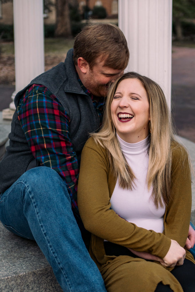 couple laughing sitting on the Old Well steps