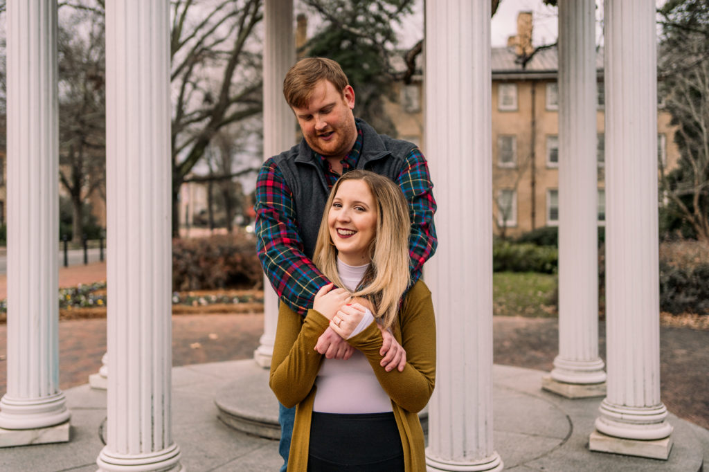 Couple smiling in front of the Old Well