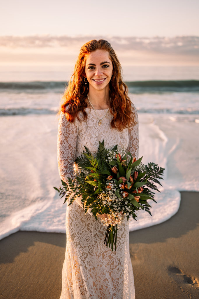 bride smiling in front of ocean