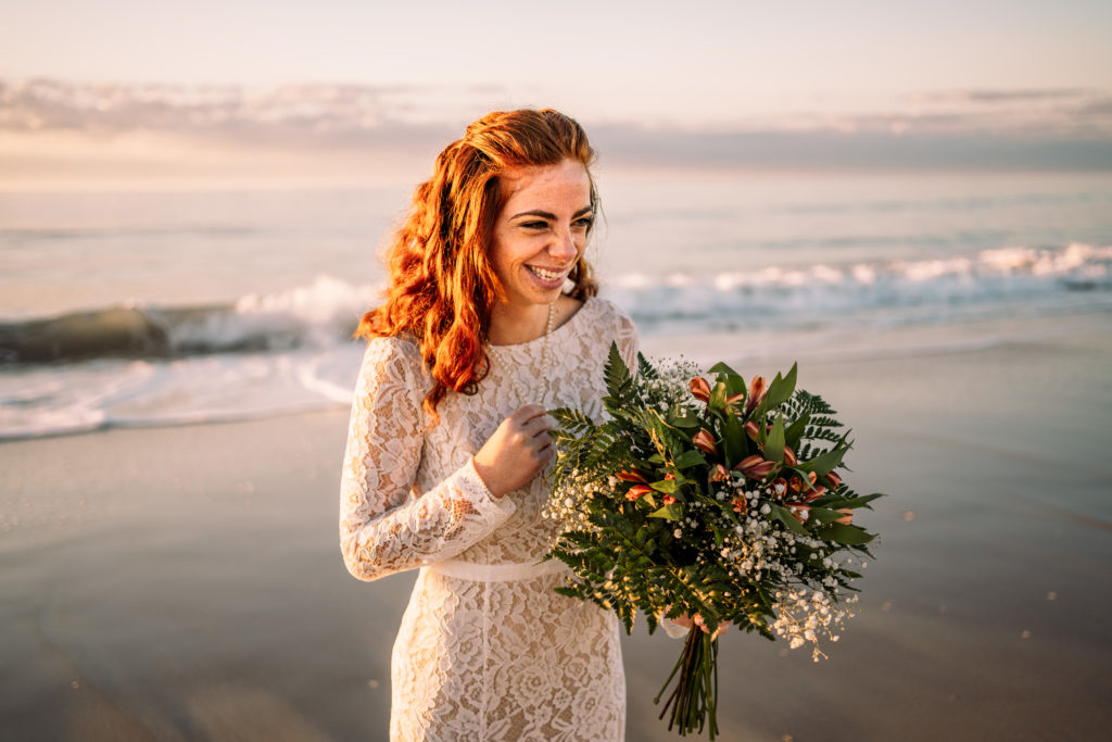 bride laughing and holding bouquet