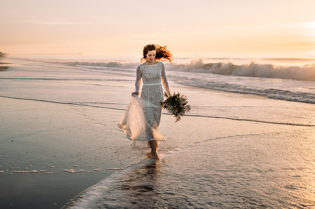 bride running along the Topsail Island shore at sunrise