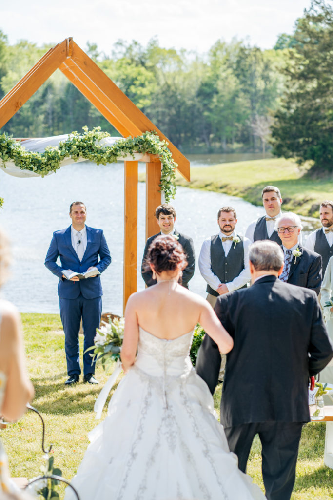 groom-watching-bride-walk-down-aisle