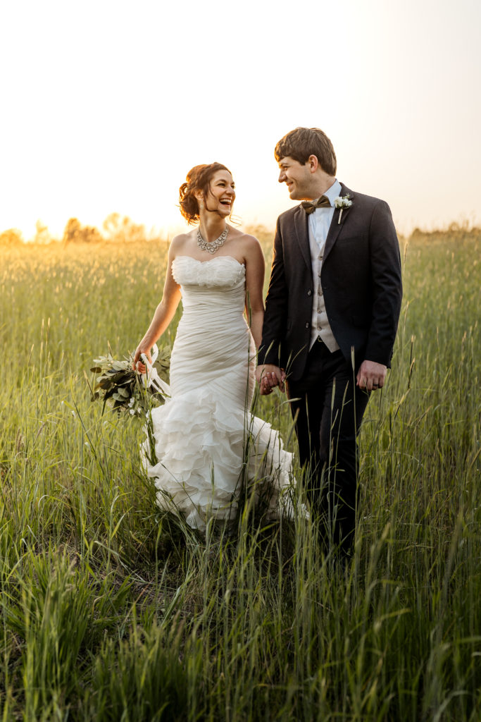bride-and-groom-walking-at-sunset