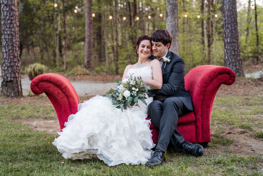 bride-and-groom-portrait-on-red-couch