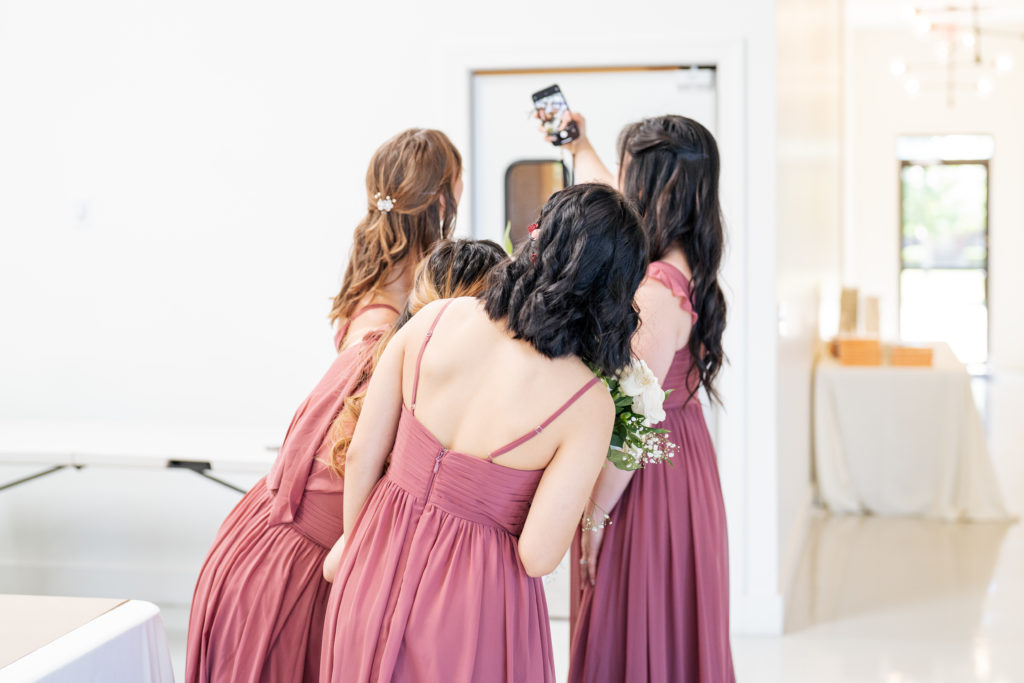 bridesmaids lean in to take a selfie