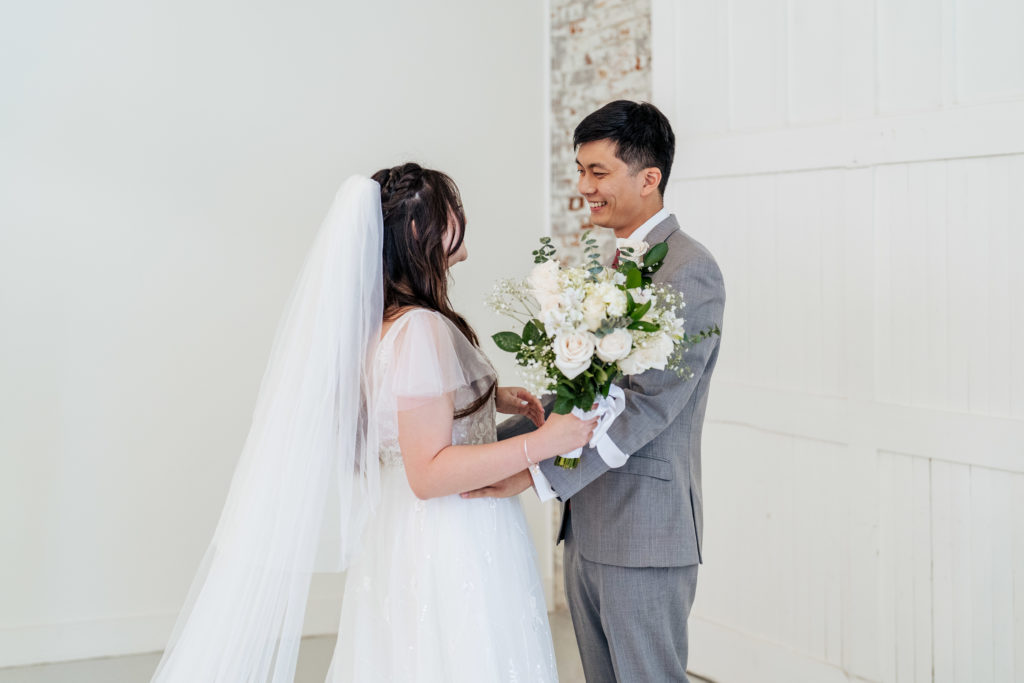 groom smiles while seeing bride for first time during first look