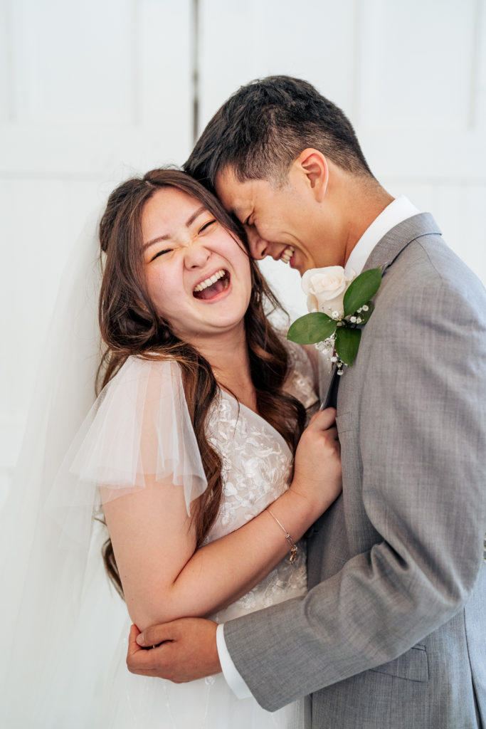 bride laughing while being held by the groom
