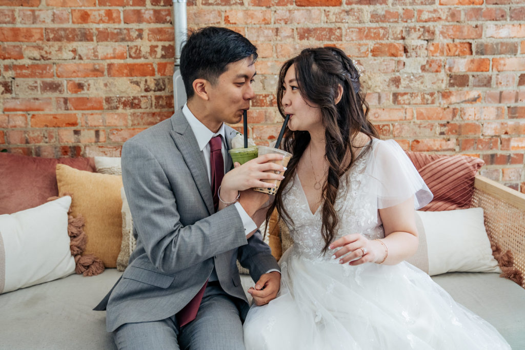 bride and groom share boba tea after the ceremony