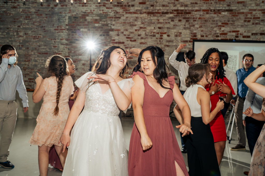bride dancing with maid of honor on the dance floor