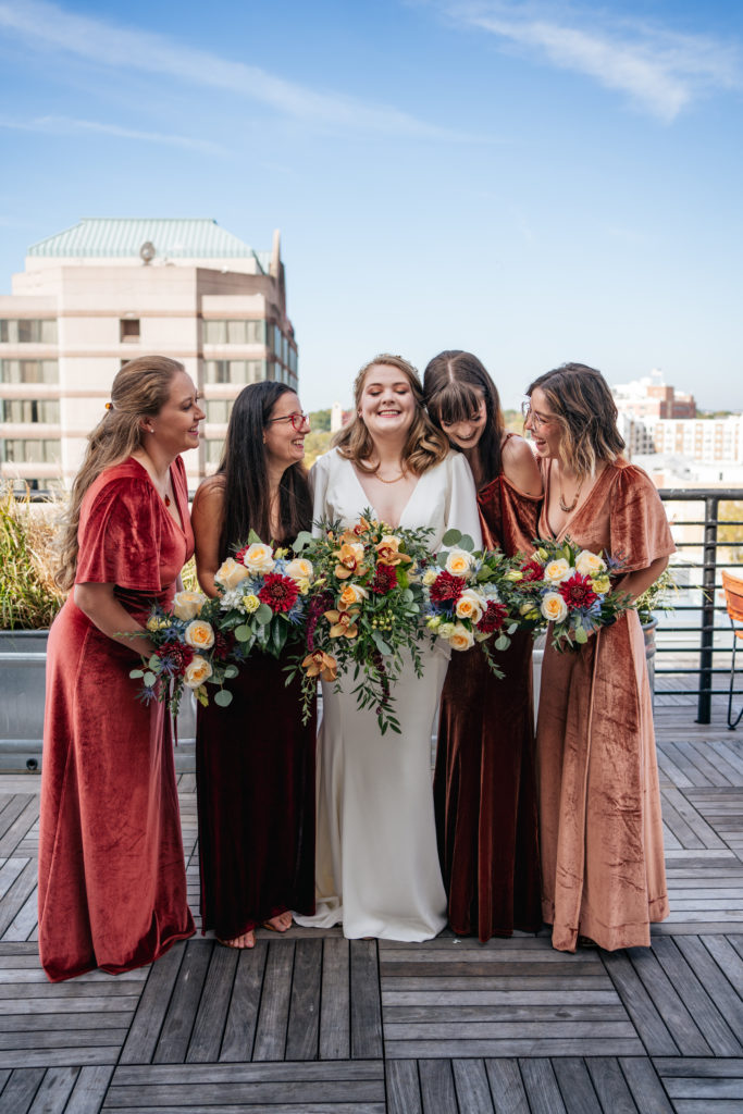 bride and bridesmaids portrait on the rooftop of the Durham Hotel