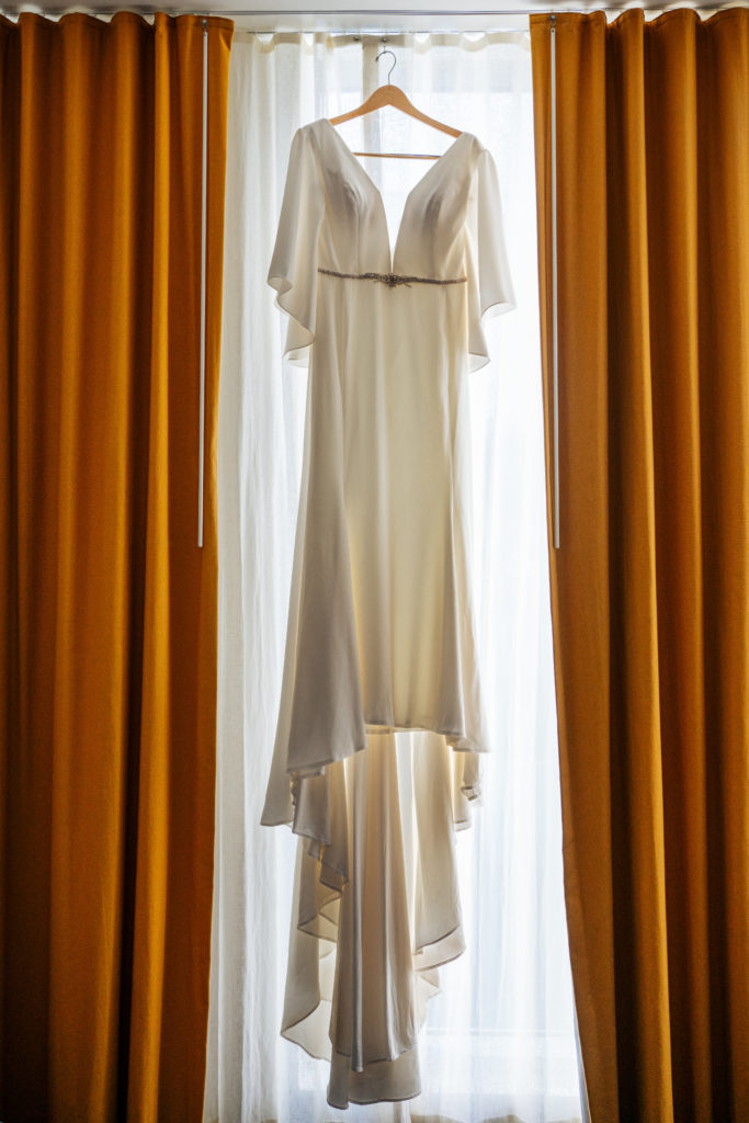wedding dress hanging from window at the Durham Hotel