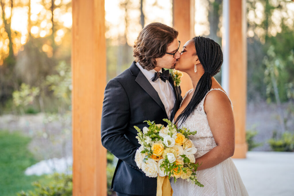bride and groom kiss wedding at the Upchurch in Cary, NC
