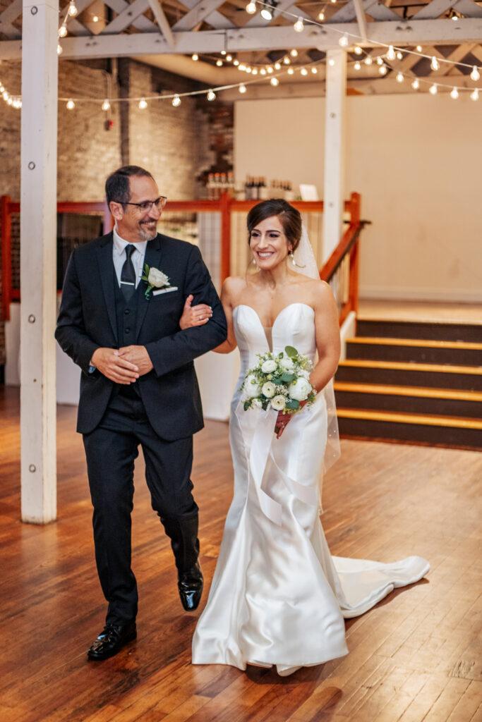 bride walking with her father down the aisle at the Stockroom at 230 wedding in downtown Raleigh, NC