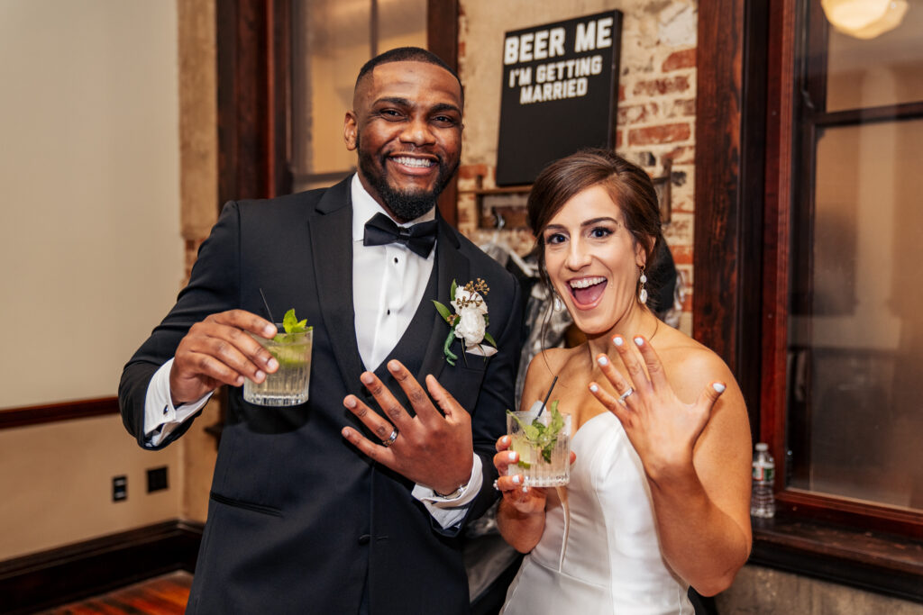 bride and groom show off their rings with cocktails at the Stockroom at 230 wedding in downtown Raleigh, NC