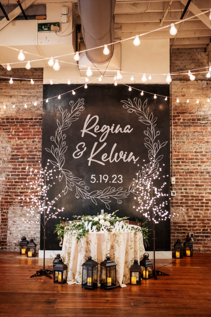 Chalk board wall in front of sweetheart table at the Stockroom at 230 wedding reception