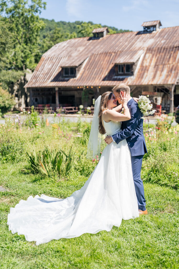 Bride and groom kiss in the garden at the Mast Farm Inn in Boone, NC