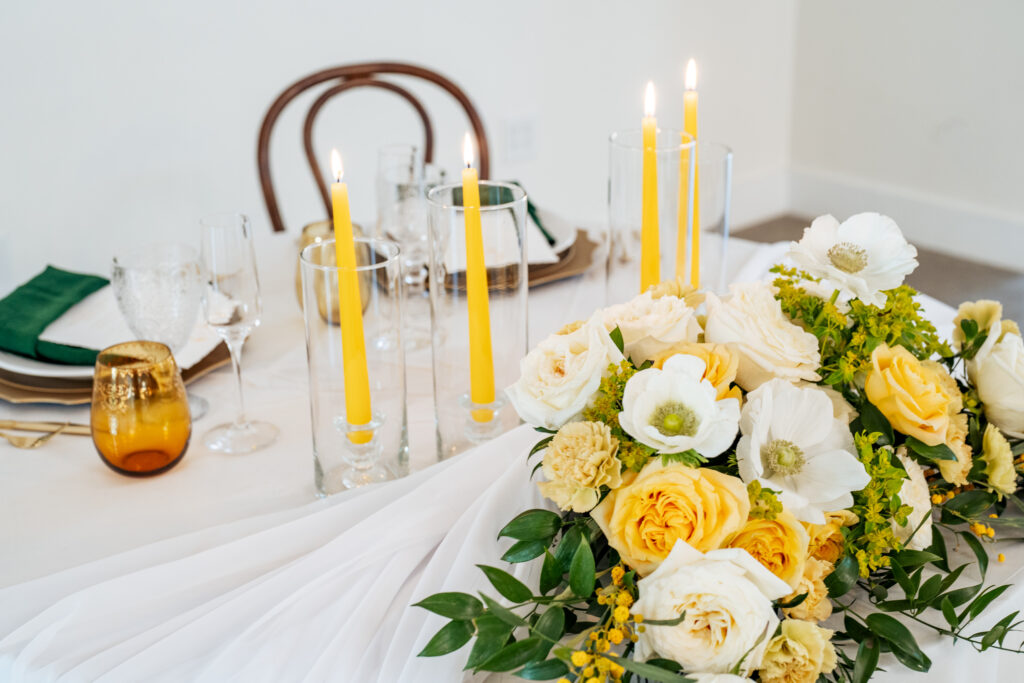 Yellow and white florals on sweetheart table.