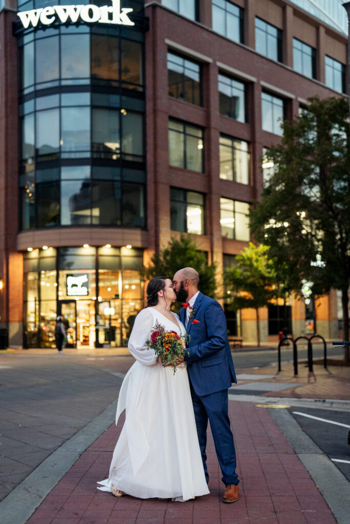 Bride and groom kiss in Downtown Durham