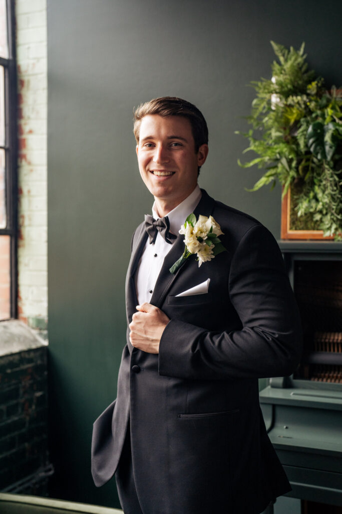Groom smiling in tuxedo at the Lincoln on Geer
