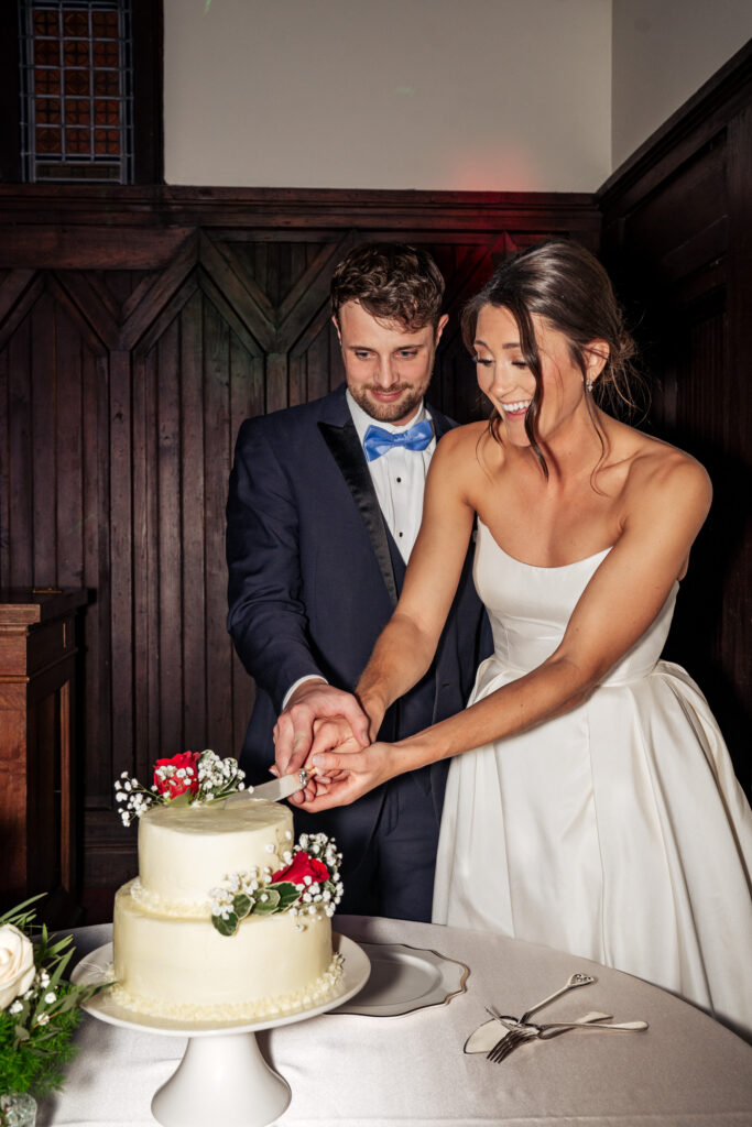 bride and groom cut wedding cake at All Saints Chapel