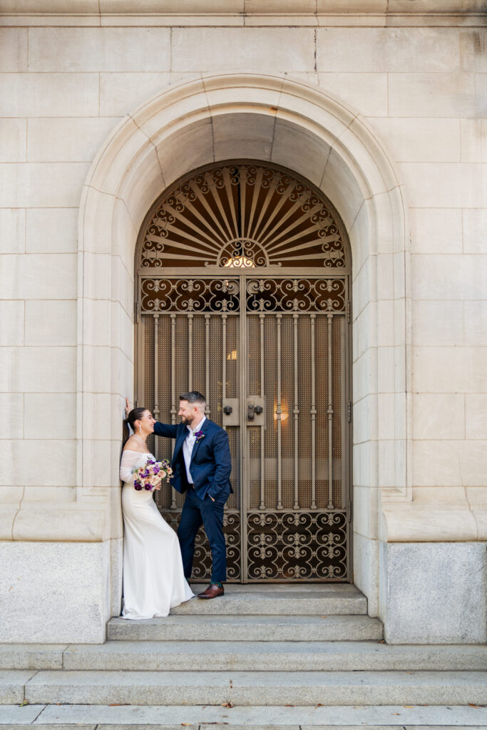 bride and groom smiling at the Capitol in Raleigh, NC