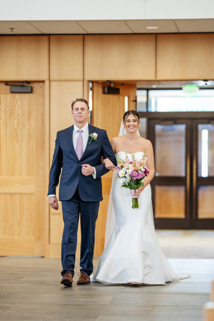 father walking bride down the aisle at St. Mary Magdalene Catholic Church