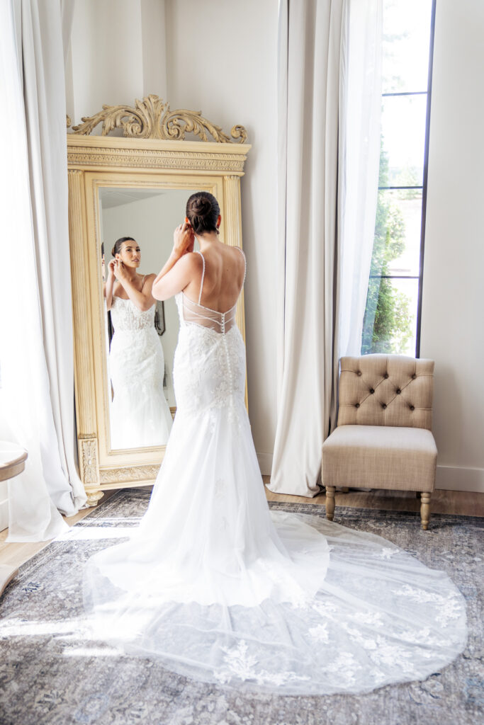 bride putting in earrings at the Maxwell wedding venue in Raleigh