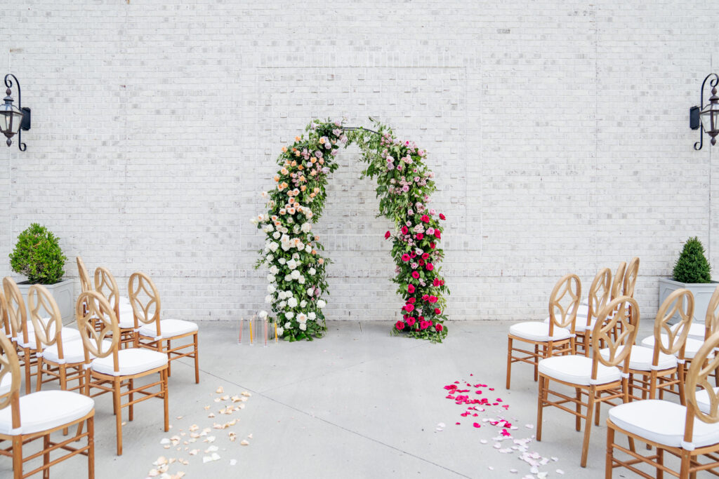 Summer wedding ceremony at the Maxwell with a colorful floral arch