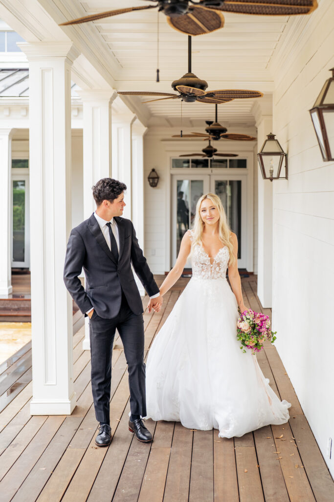 Bride and groom holding hands and walking