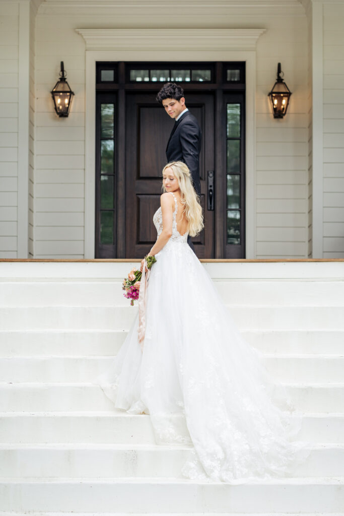 bride and groom walking up the front porch stairs of Southern coastal home in Wilmington, NC