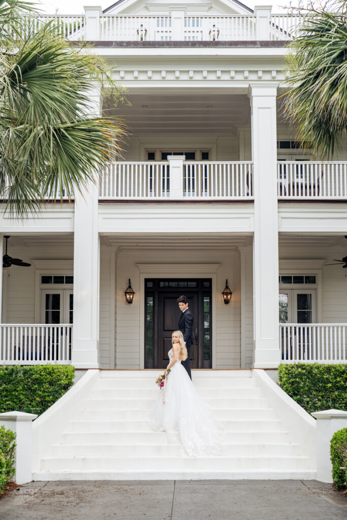 wedding portrait in front of white house with palm trees