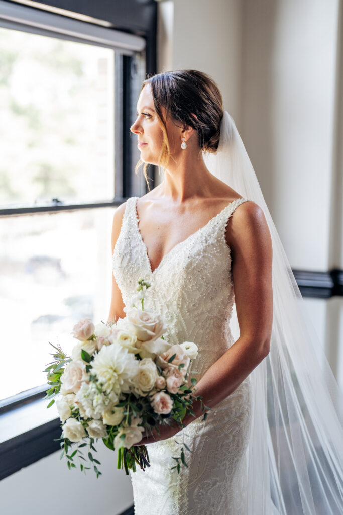 bride looks out window in bridal suite at Market Hall