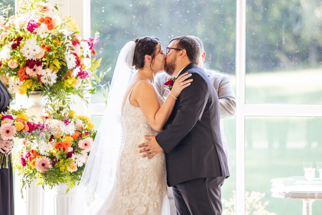 bride and groom first kiss at Daniel's Ridge wedding venue in Sanford, NC