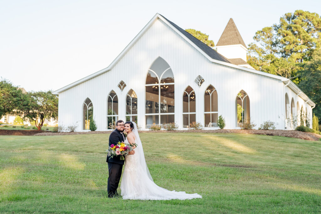 bride and groom portrait at Daniel's Ridge wedding venue in front of the chapel