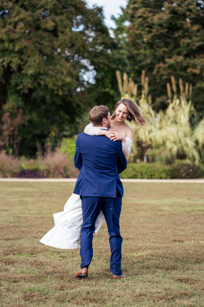 groom spins bride around at JC Raulston Arboretum