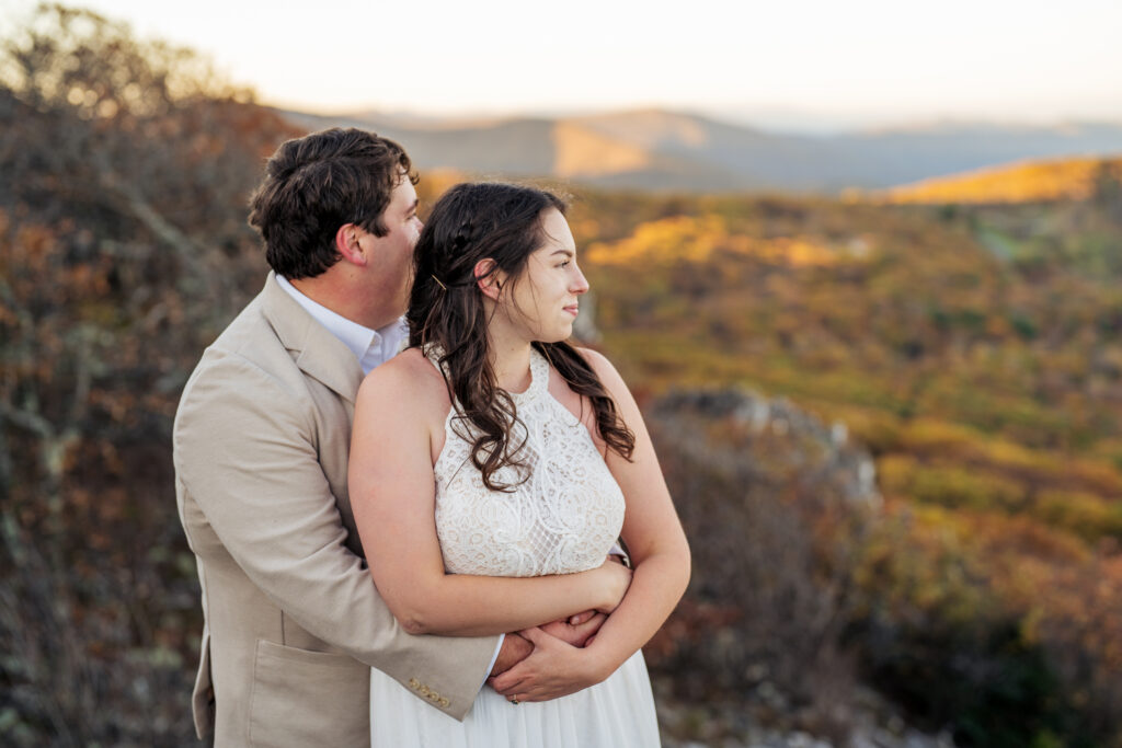 couple holding and looking out on the Shenandoah mountains