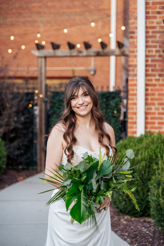 bride holds foliage bouquet at Durham, NC wedding