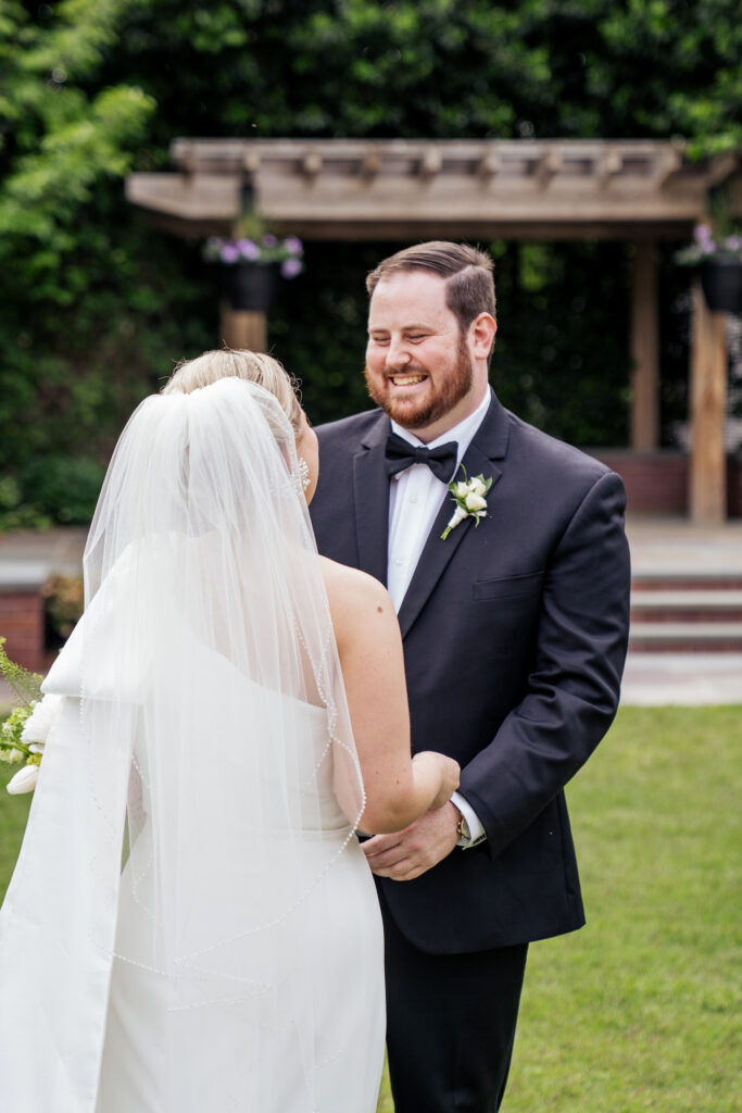 groom smiling during first look