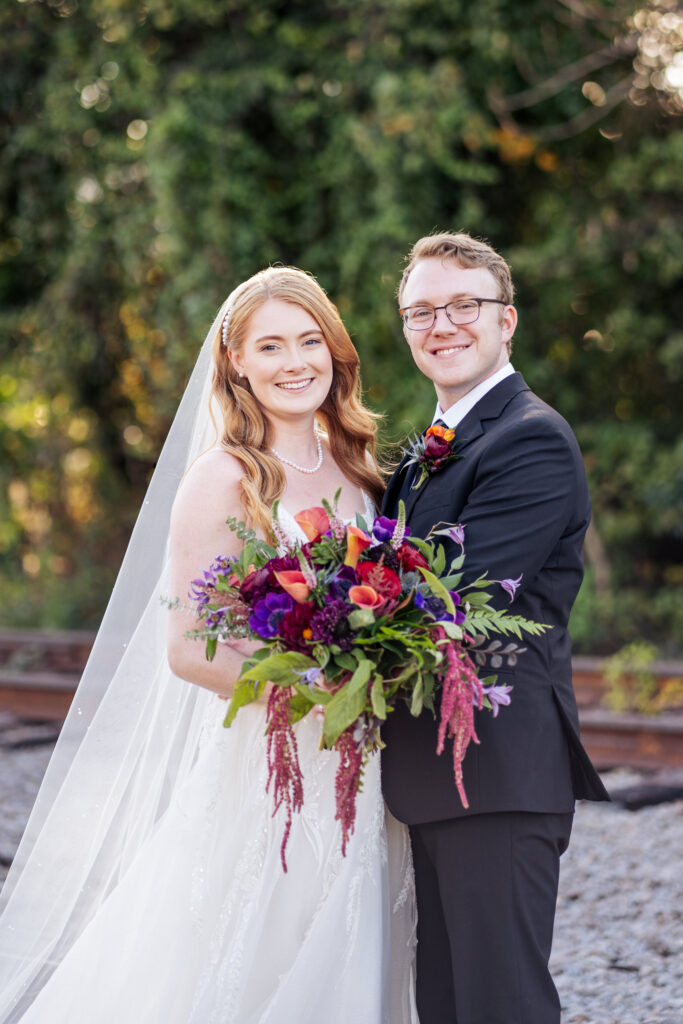 bride and groom smiling for portrait