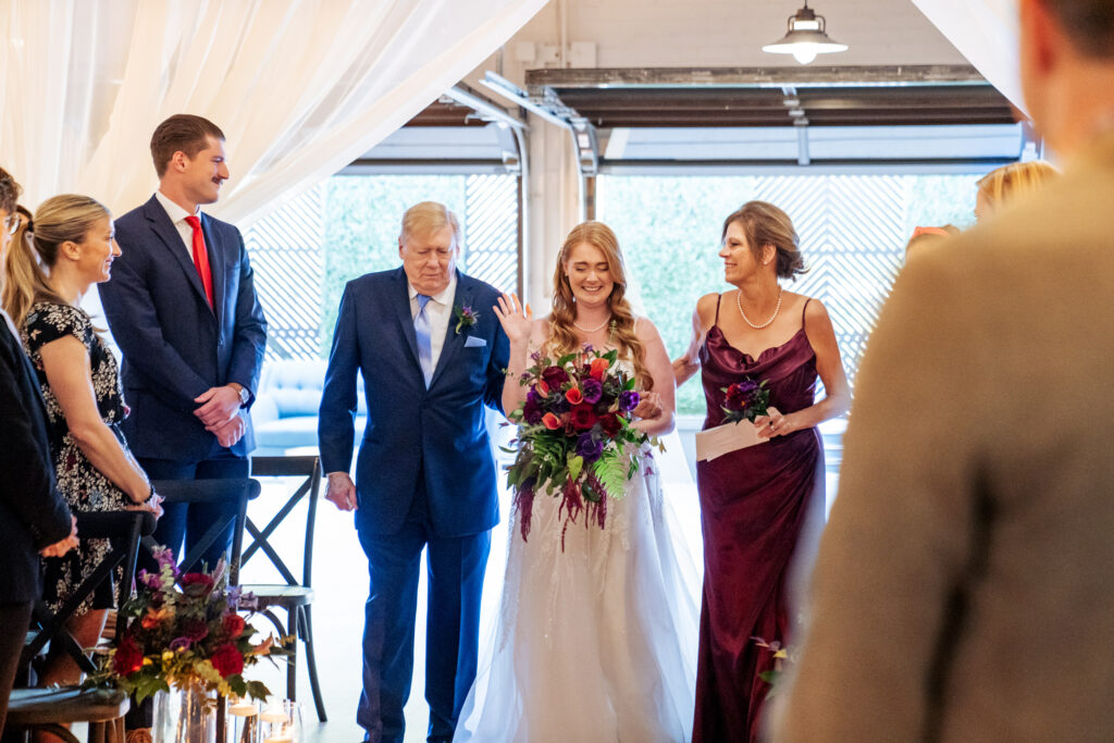 bride crying and walking down the aisle