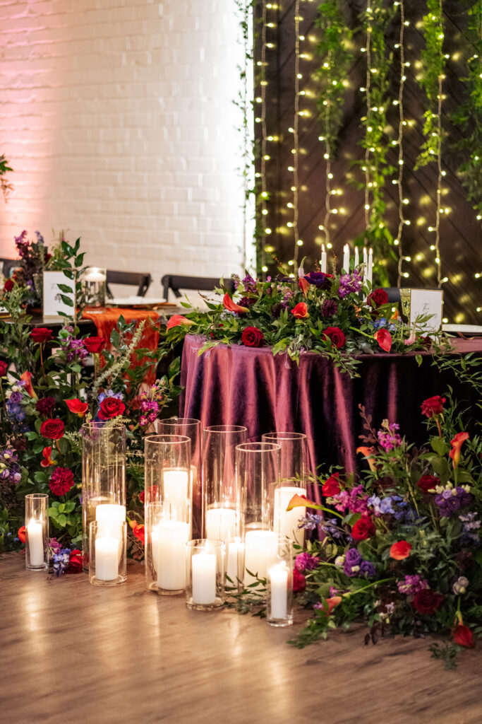 sweetheart table with candles at traine at seaboard station