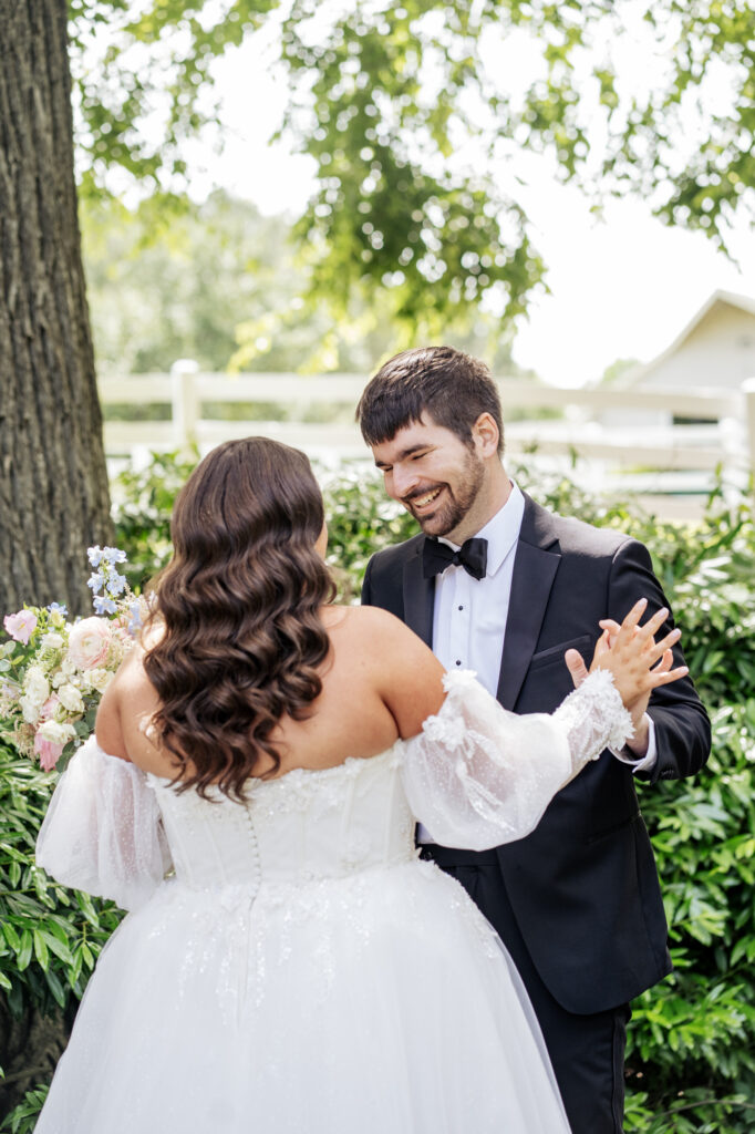 Groom sees bride for first time under oak tree at Historic Wakefield Barn