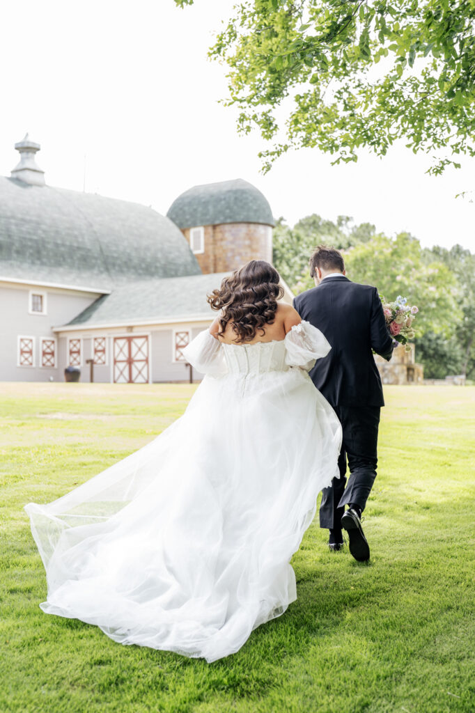 bride and groom walking at Historic Wakefield Barn