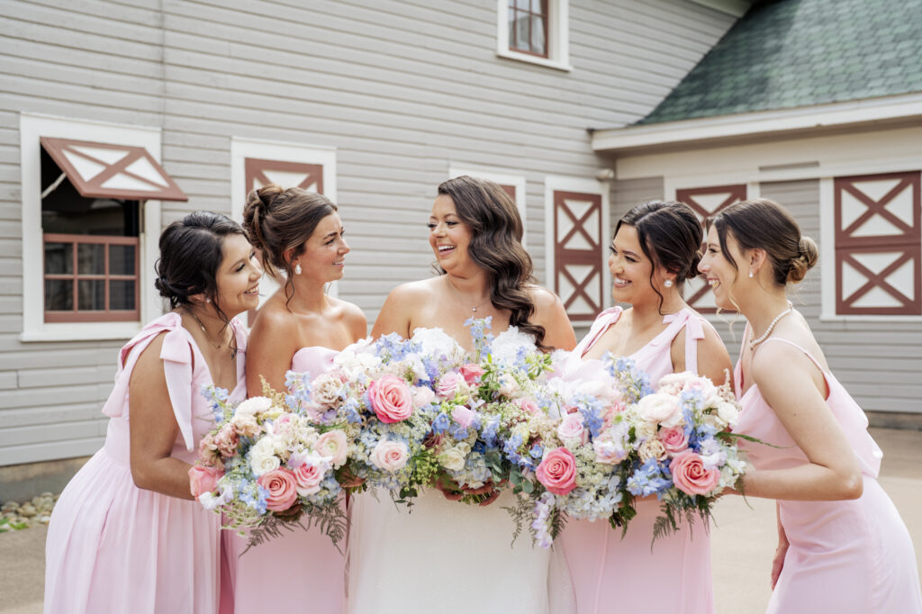 bride laughing with bridesmaids at Historic Wakefield Barn
