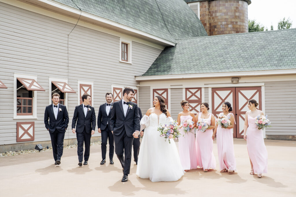 wedding party walking in front of Historic Wakefield Barn