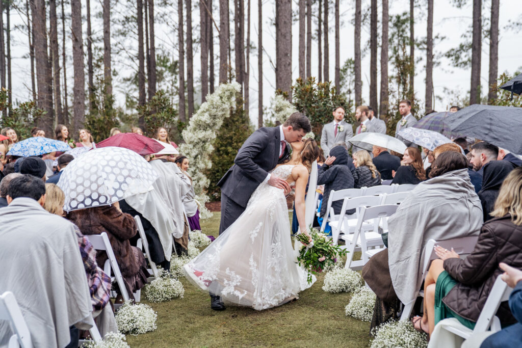 aisle dip kiss at the Upchurch outdoor wedding ceremony