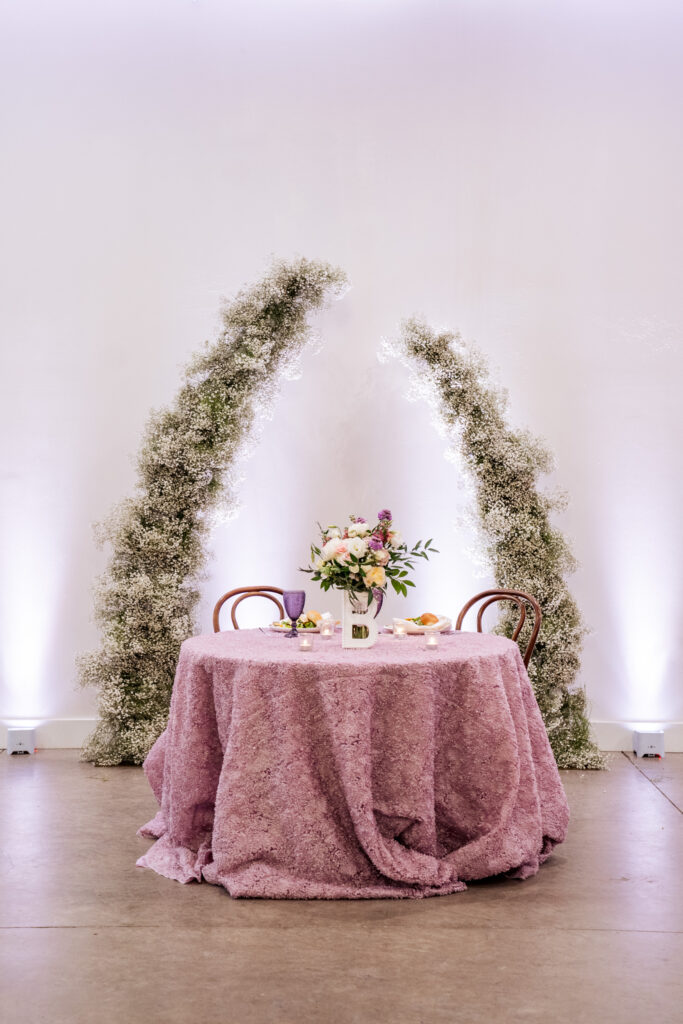 sweetheart table with pink table cloth at the Upchurch wedding reception