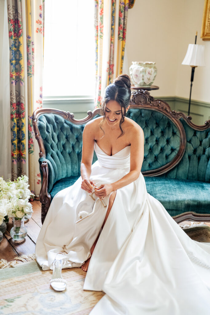 bride putting on her shoes at Haywood Hall in the bridal suite