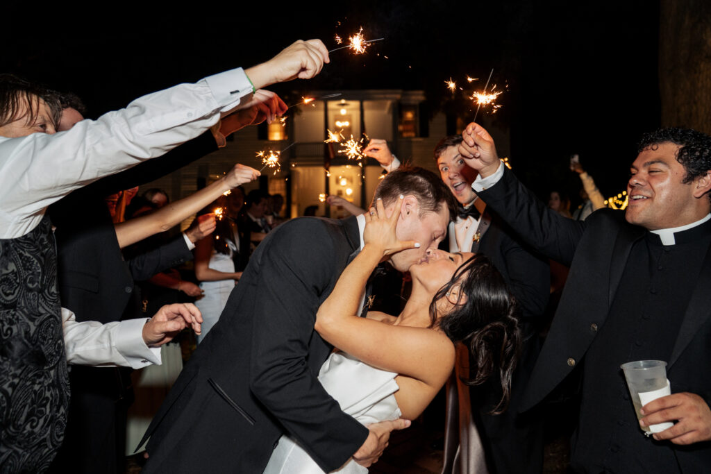 bride and groom kiss during sparkler send off at Haywood Hall
