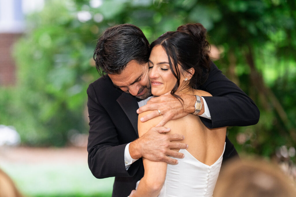 bride and father hug at a wedding in Raleigh, NC